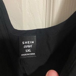 Black jumpsuit with decorative buttons and drawstring